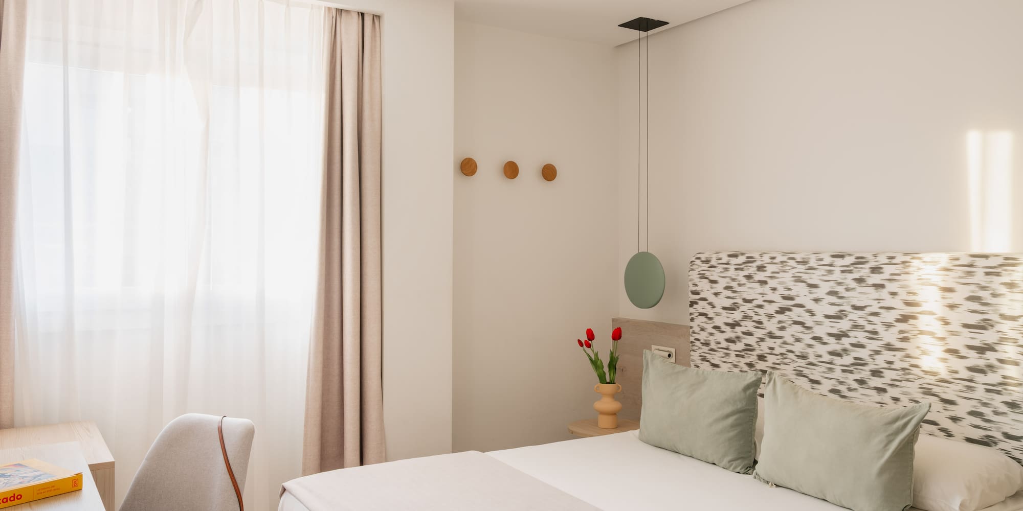 a bedroom with a fan and a bed