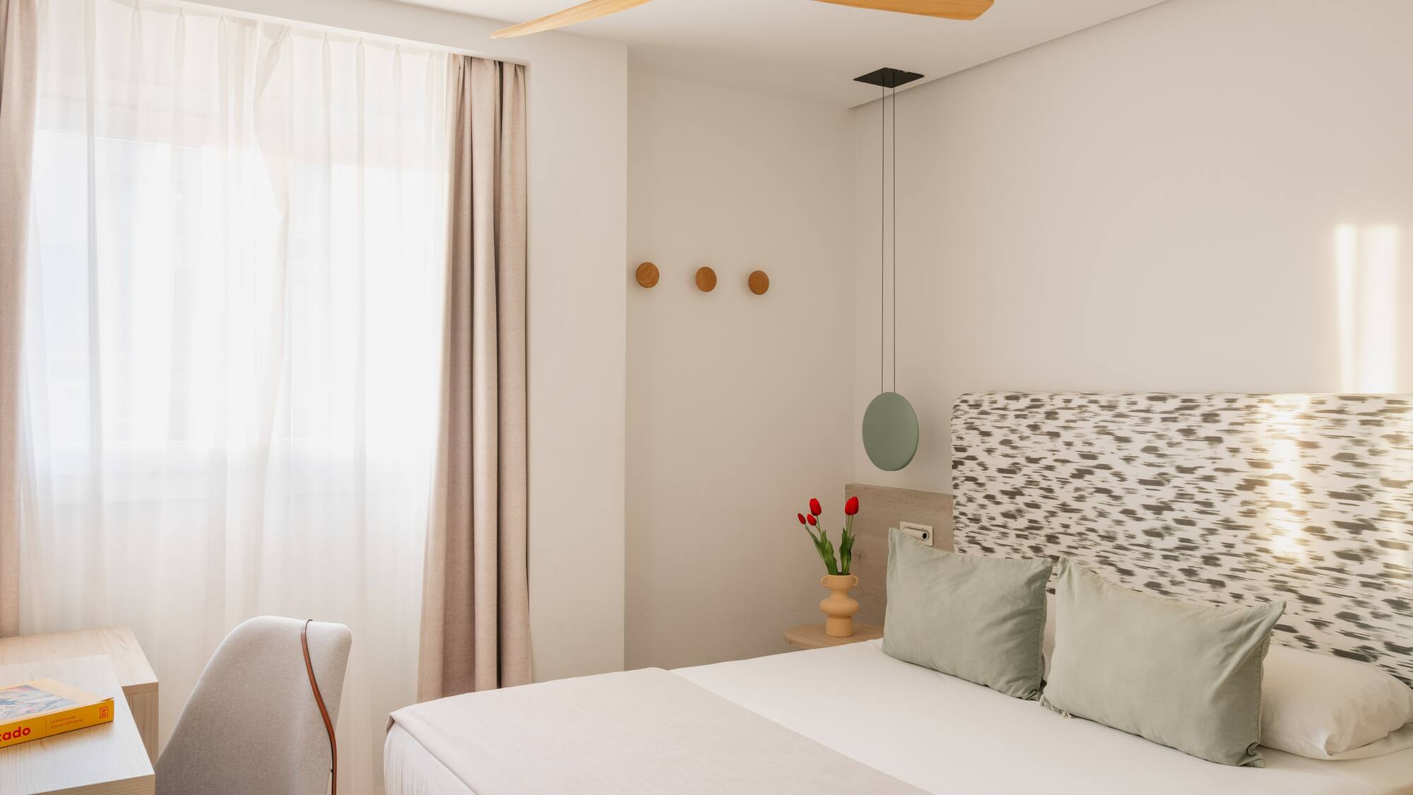 a bedroom with a fan and a bed