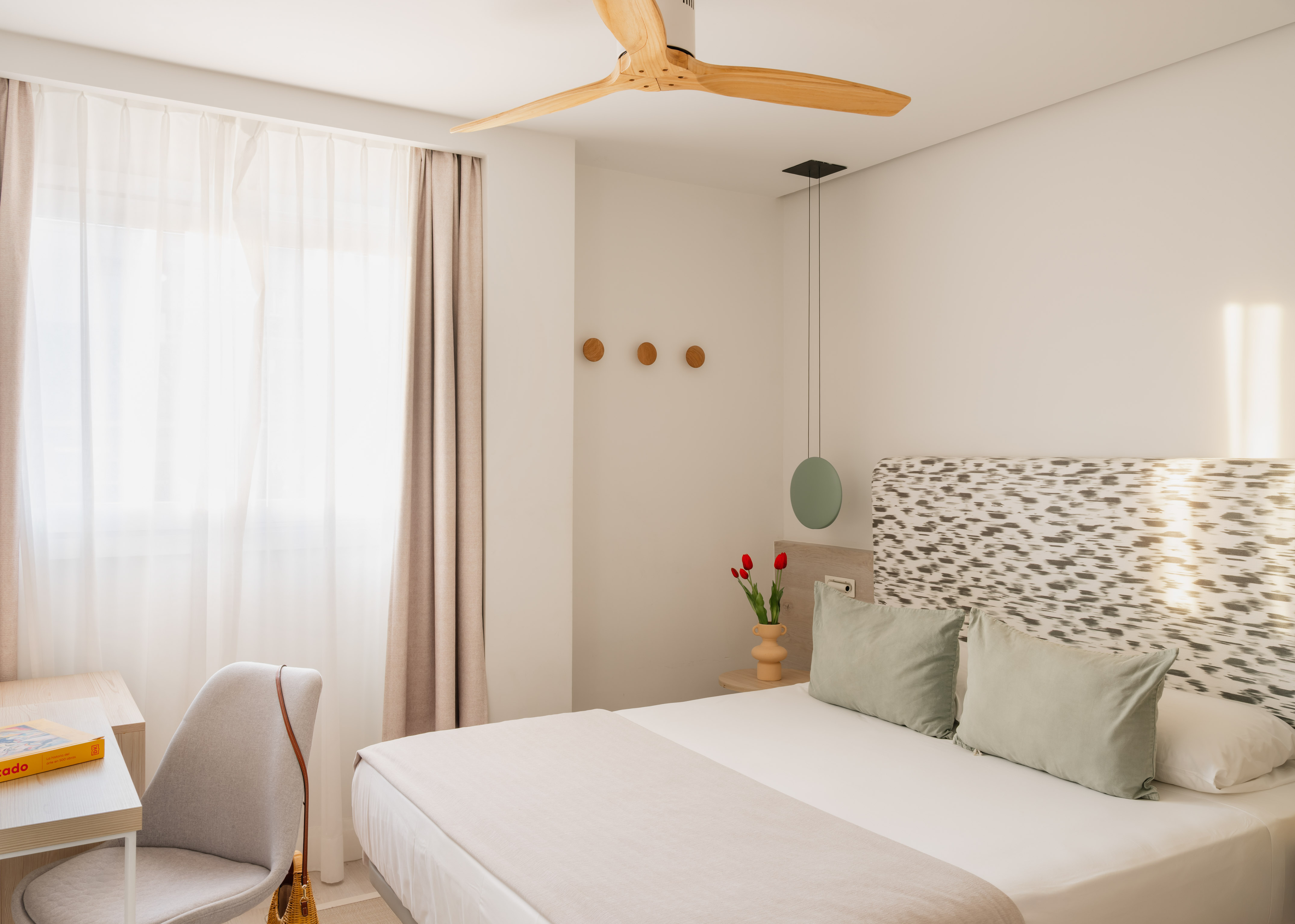 a bedroom with a fan and a bed