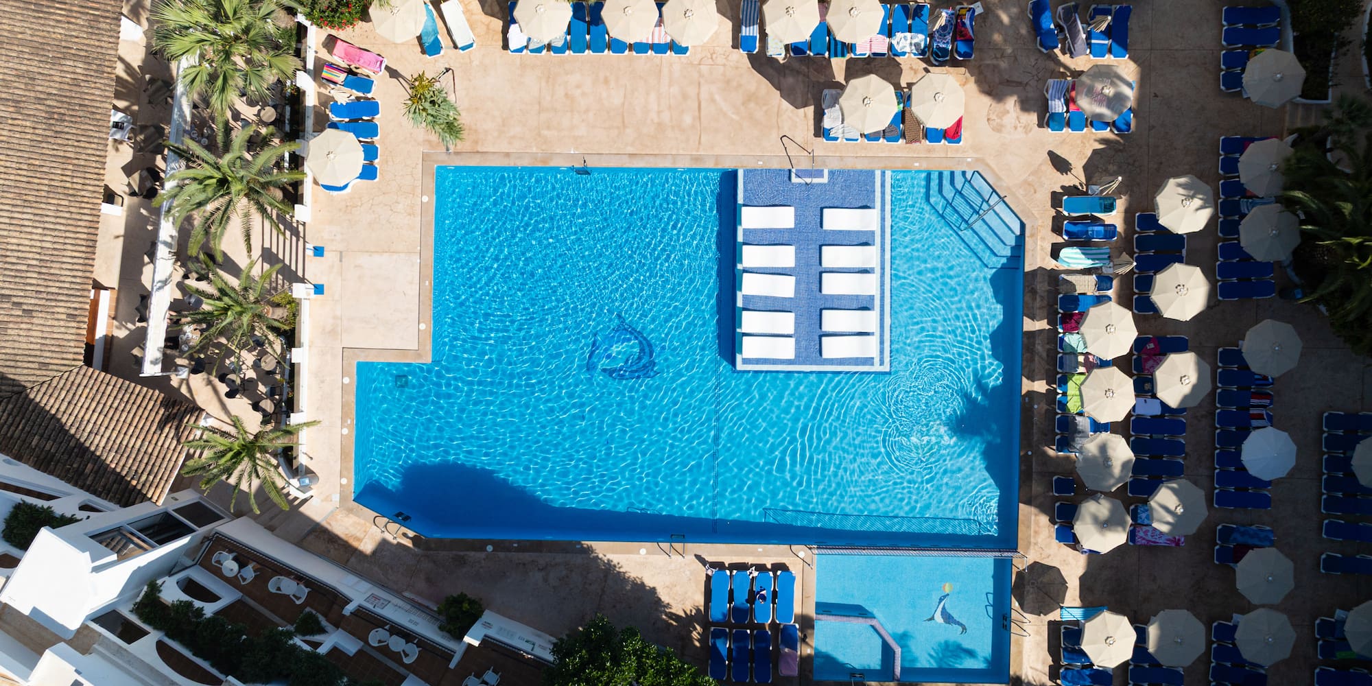 a swimming pool with umbrellas and chairs
