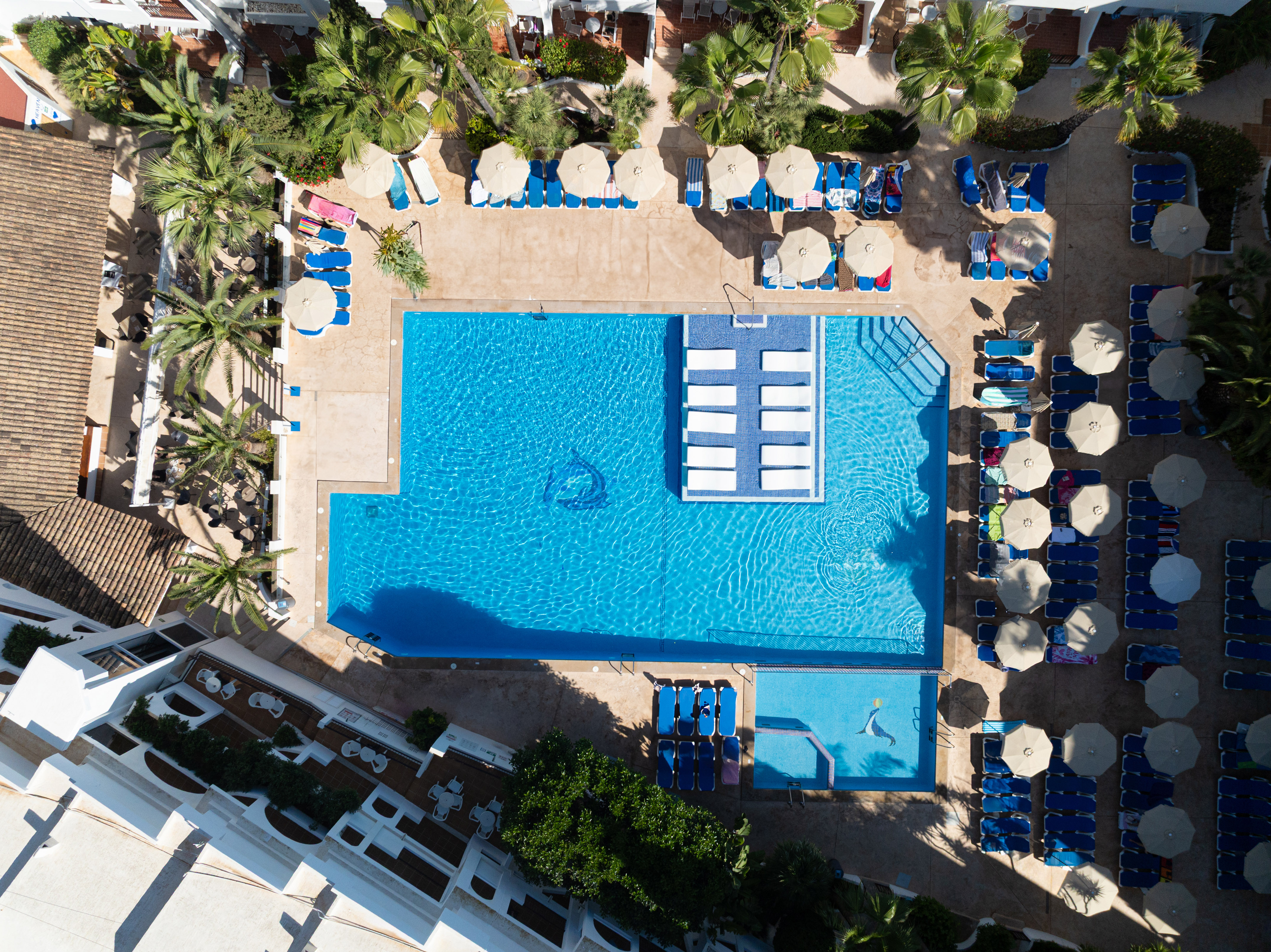 a swimming pool with umbrellas and chairs