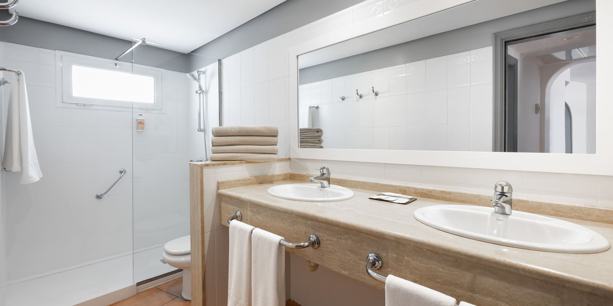 a bathroom with a shower and two sinks