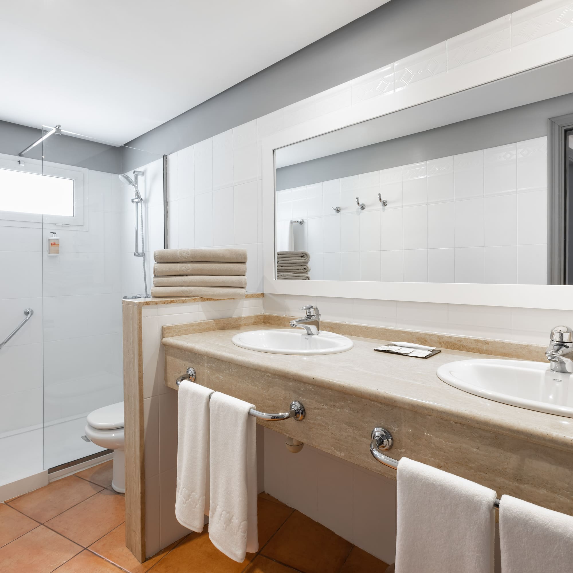a bathroom with a shower and two sinks
