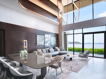 a living room with a large table and chairs