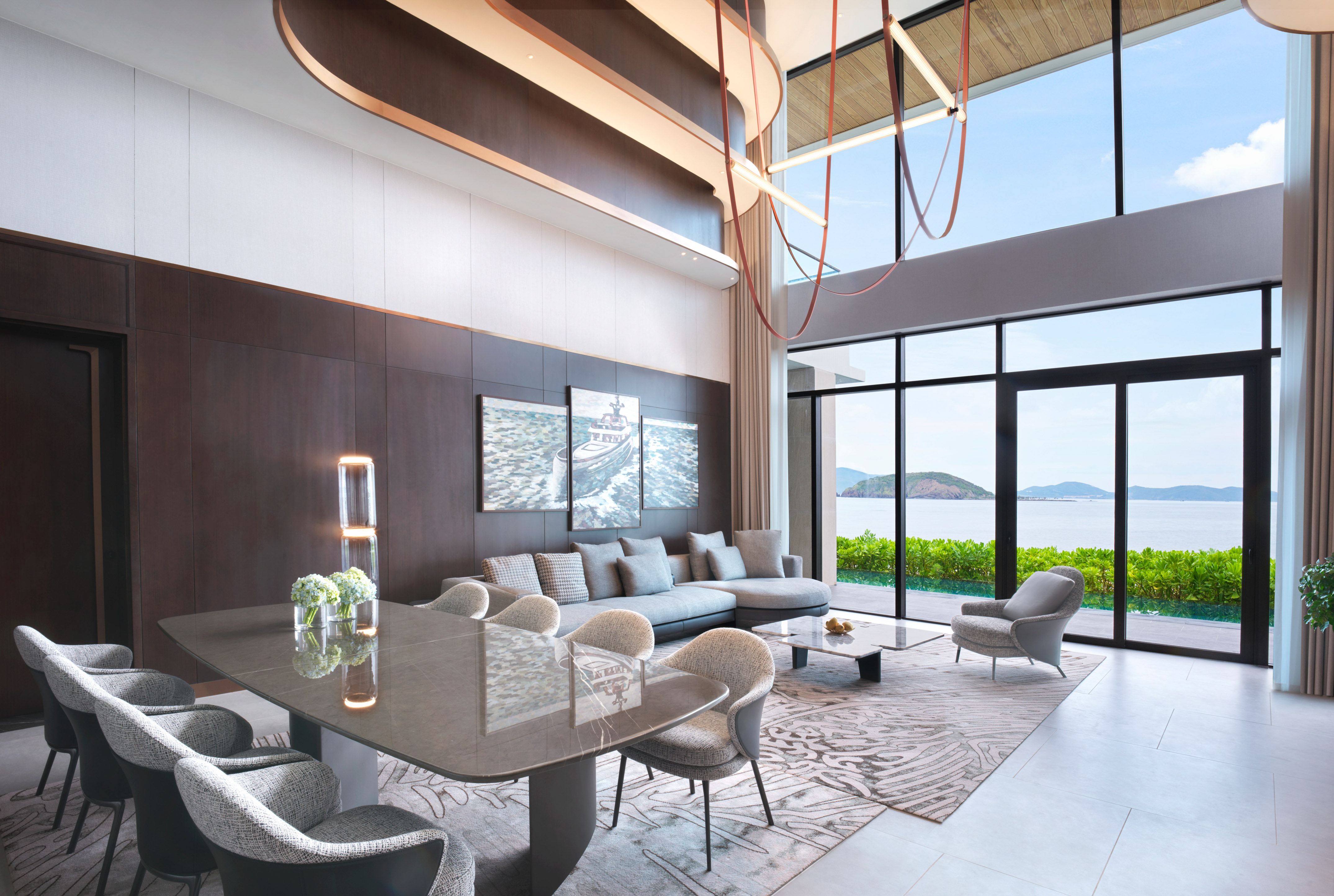 Modern luxury living and dining room with panoramic ocean views.