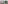 Sailboat on sparkling sea beyond blurred outdoor dining table.