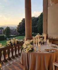 a table set up with candles and flowers on it