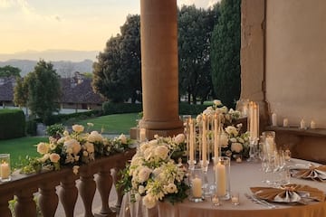 a table set up with candles and flowers on it