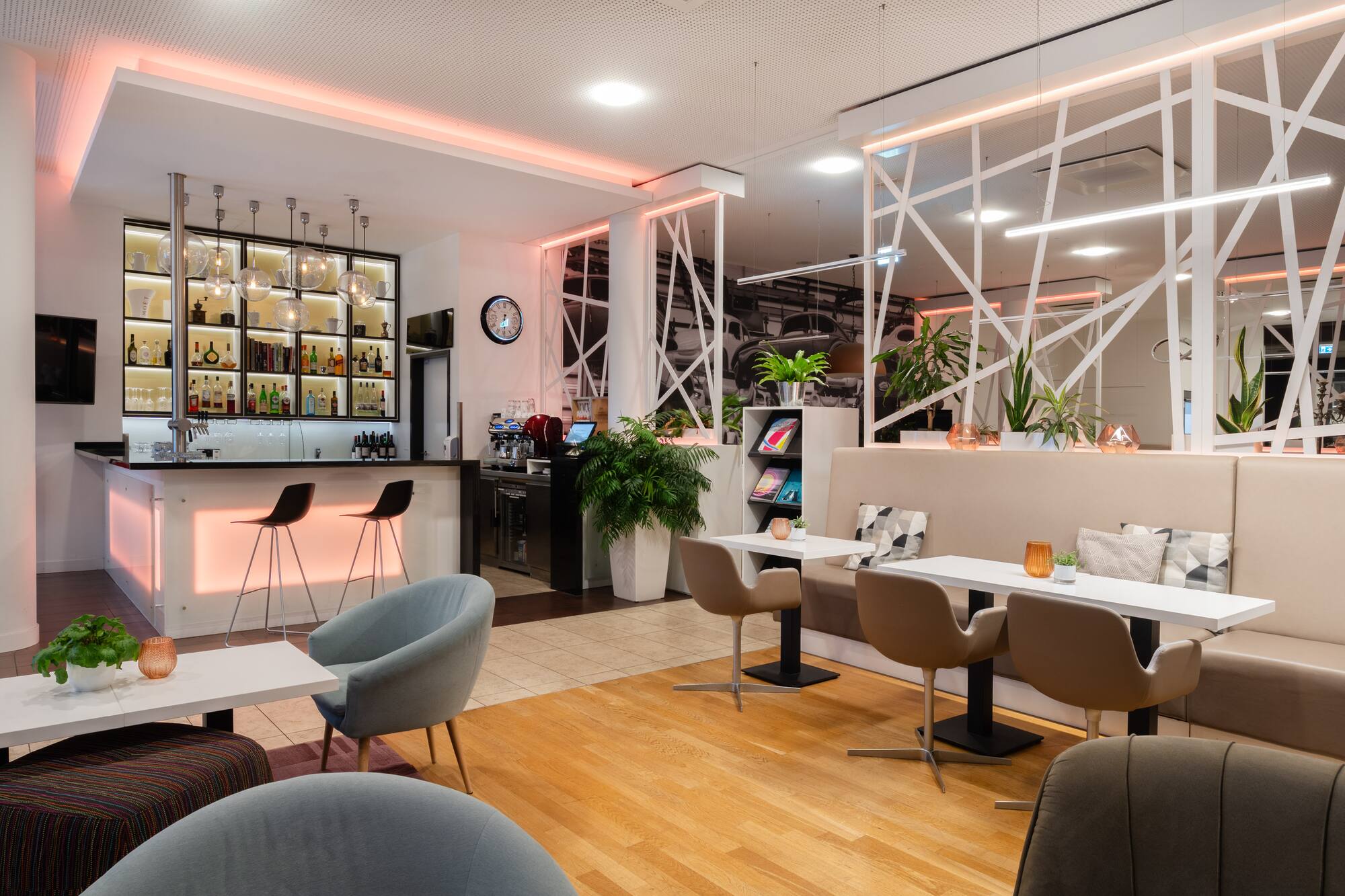 Modern hotel bar and lounge with warm ambient lighting and diverse seating.