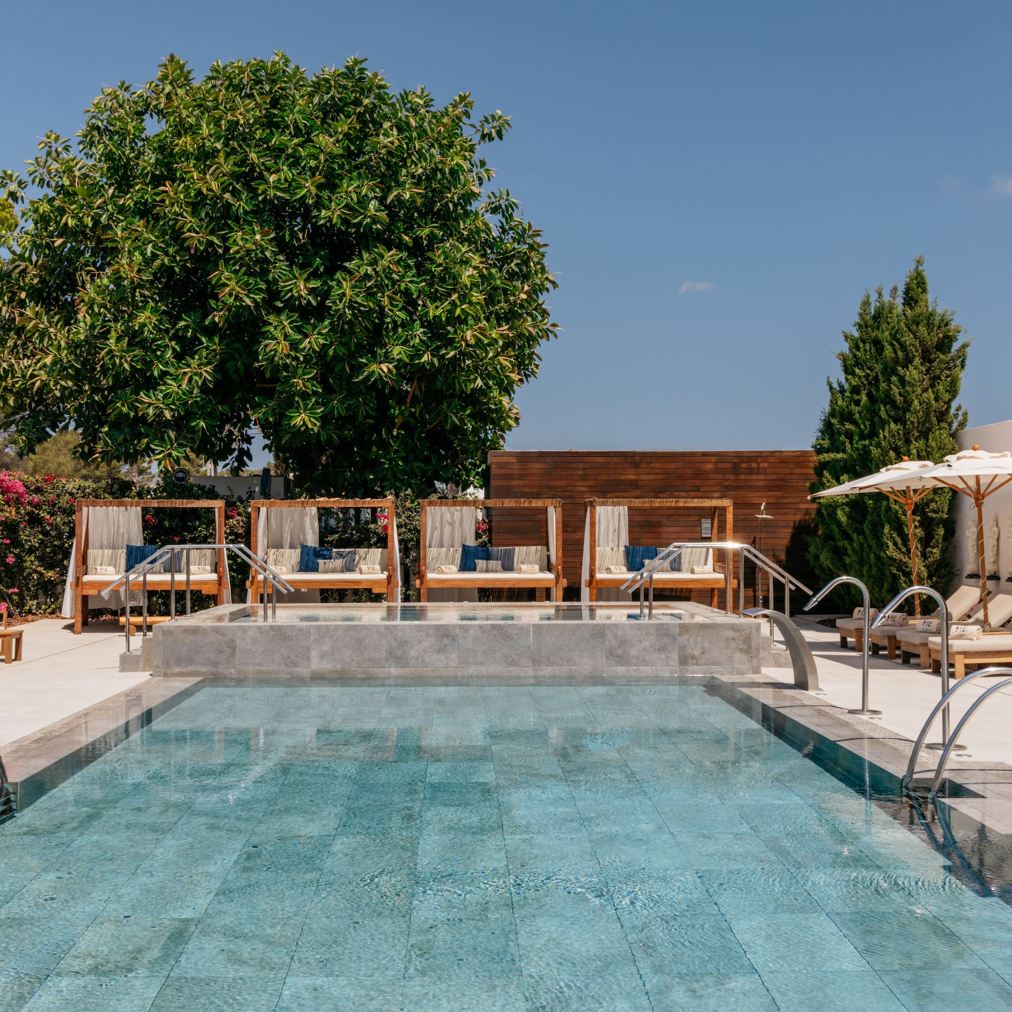 a pool with chairs and umbrellas