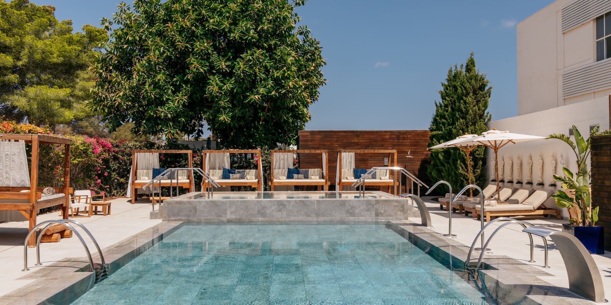 a pool with chairs and umbrellas.