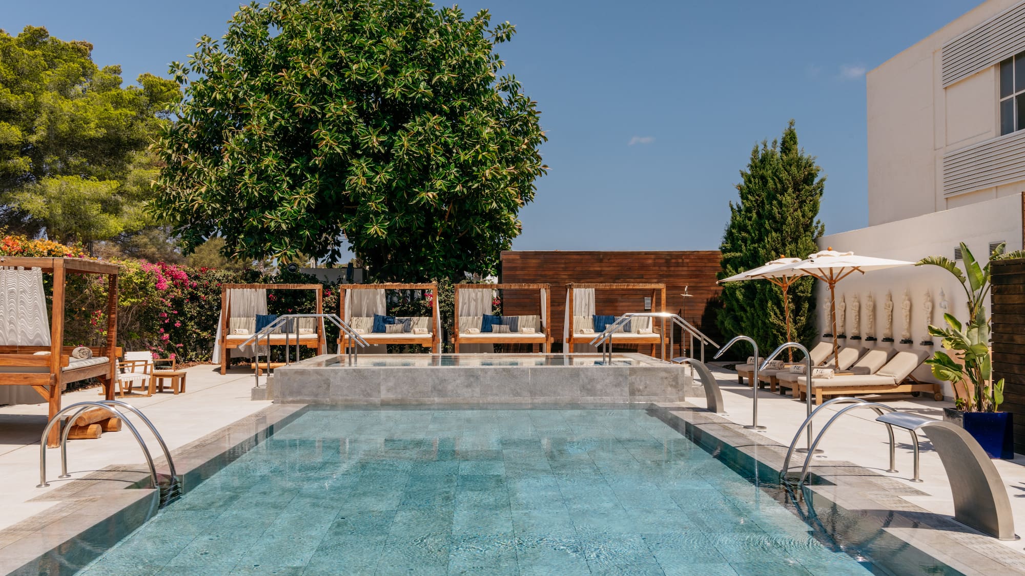a pool with chairs and umbrellas.