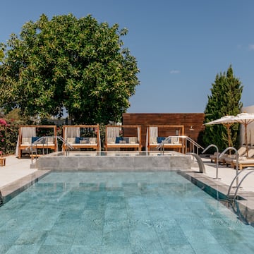 a pool with chairs and umbrellas