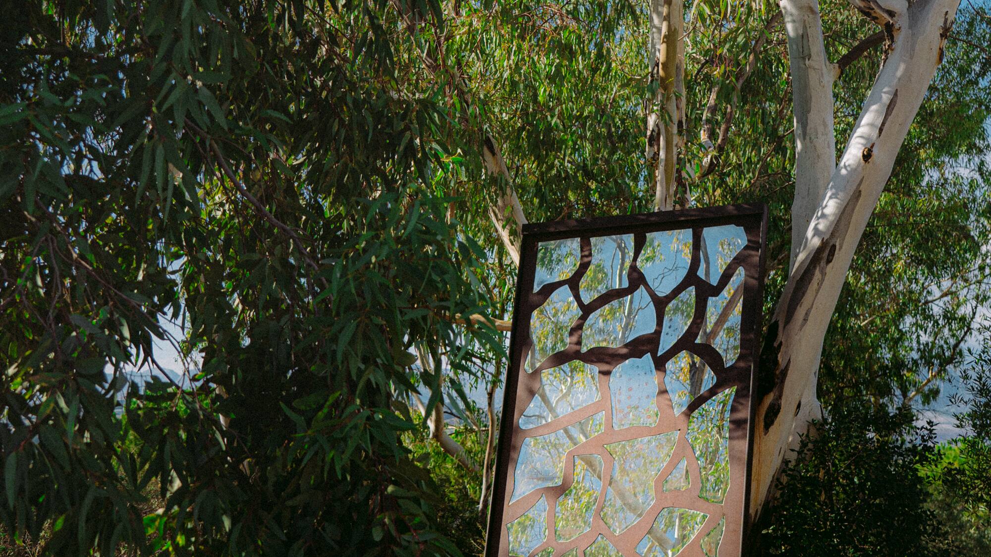 a metal sculpture in a tree