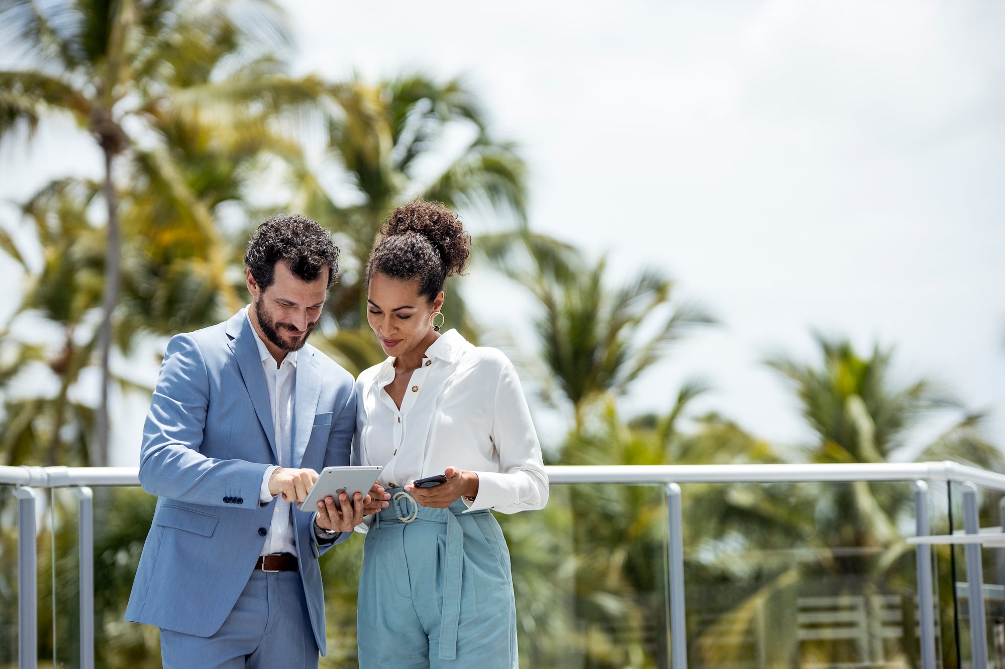 a man and woman looking at a tablet