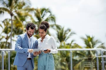 a man and woman looking at a tablet