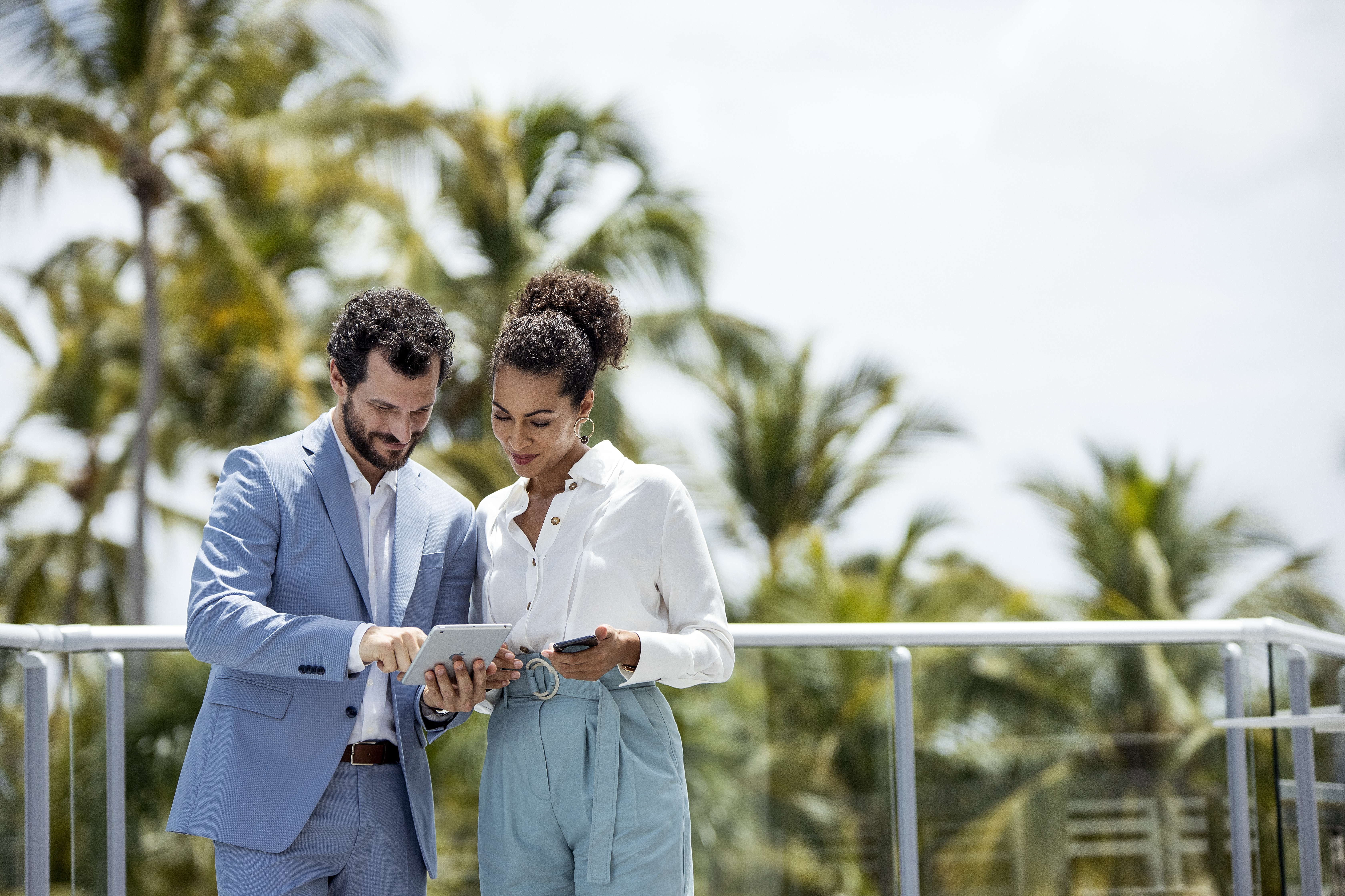 a man and woman looking at a tablet