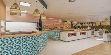 a restaurant with a blue and white counter and wicker baskets from ceiling