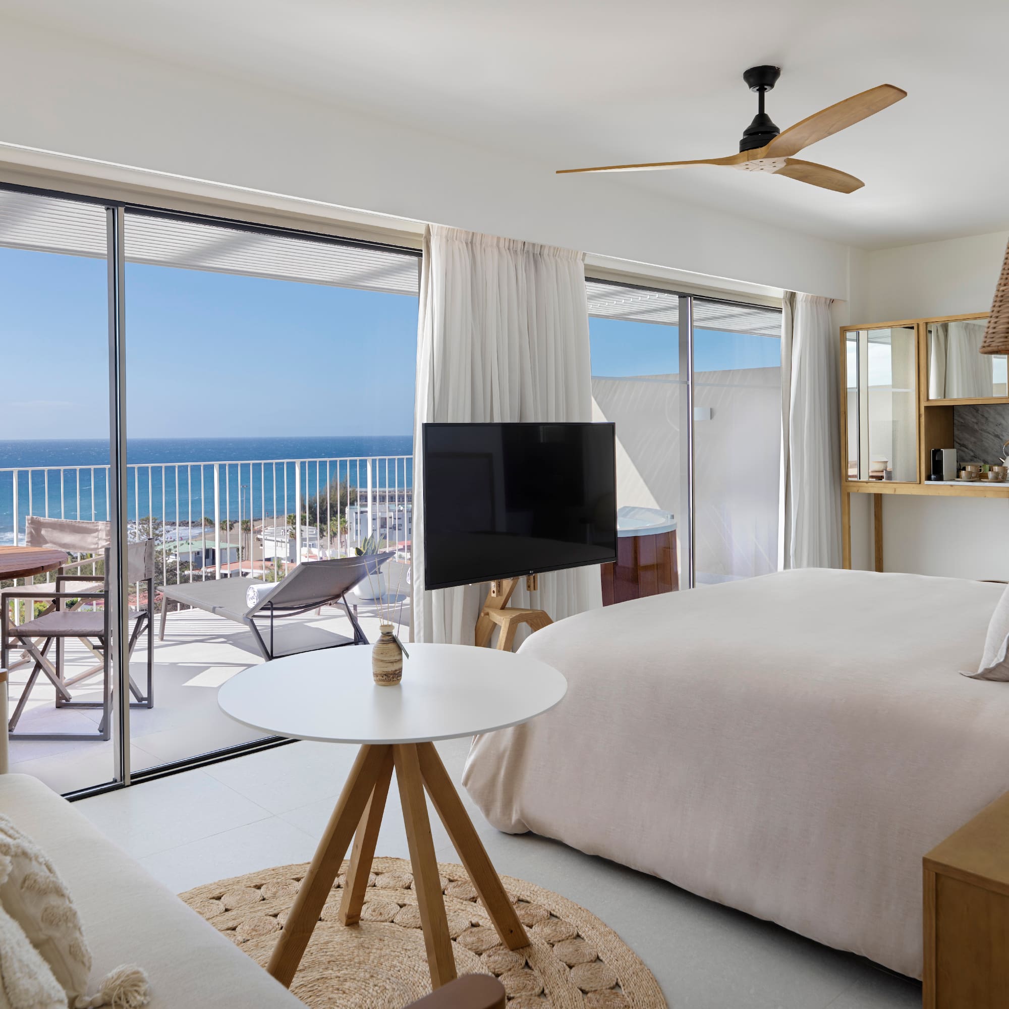 a bedroom with a television and a large window