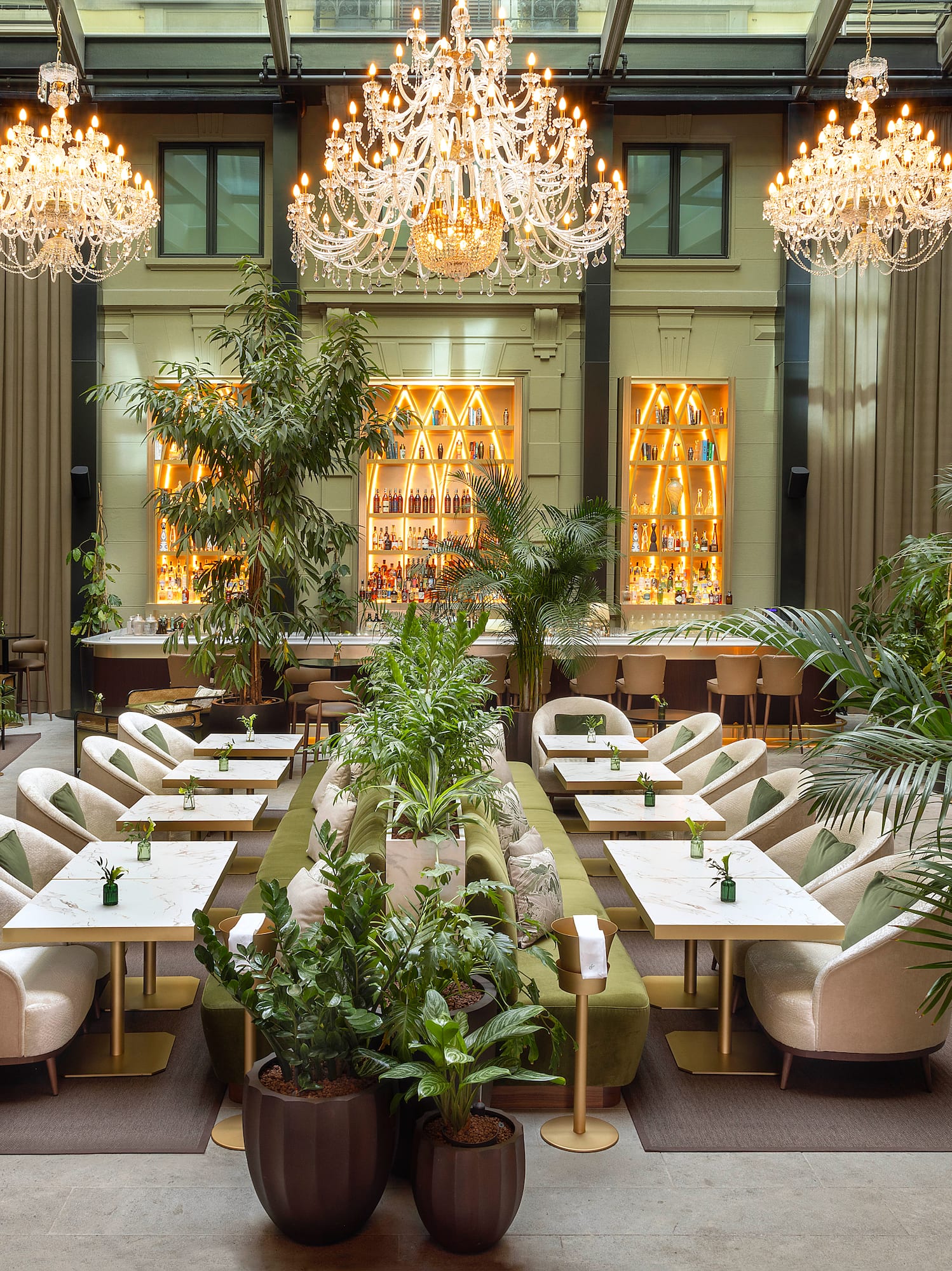 a room with tables and chairs and chandeliers