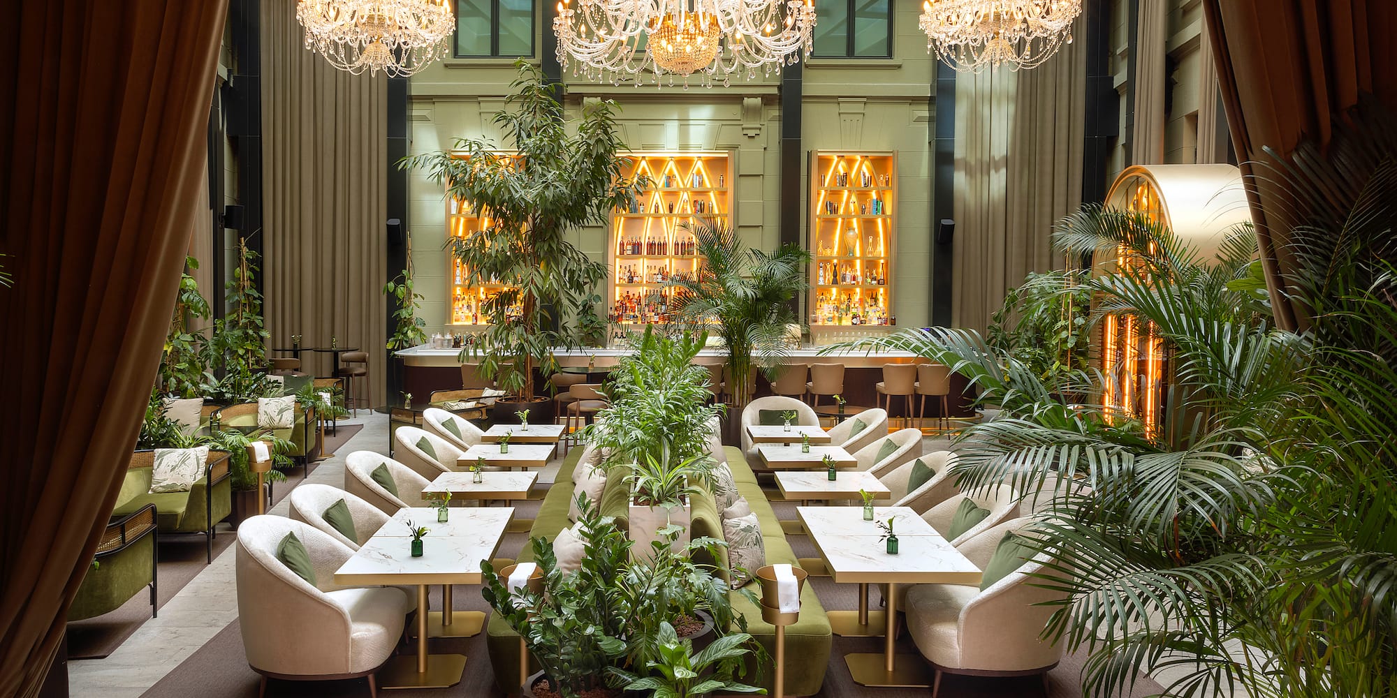 a room with tables and chairs and chandeliers