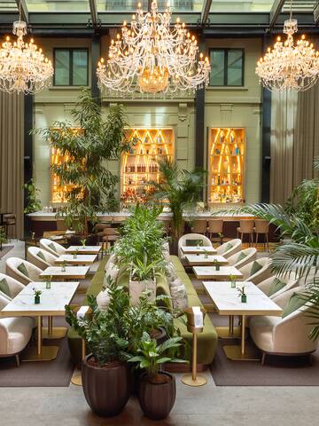 a room with tables and chairs and chandeliers