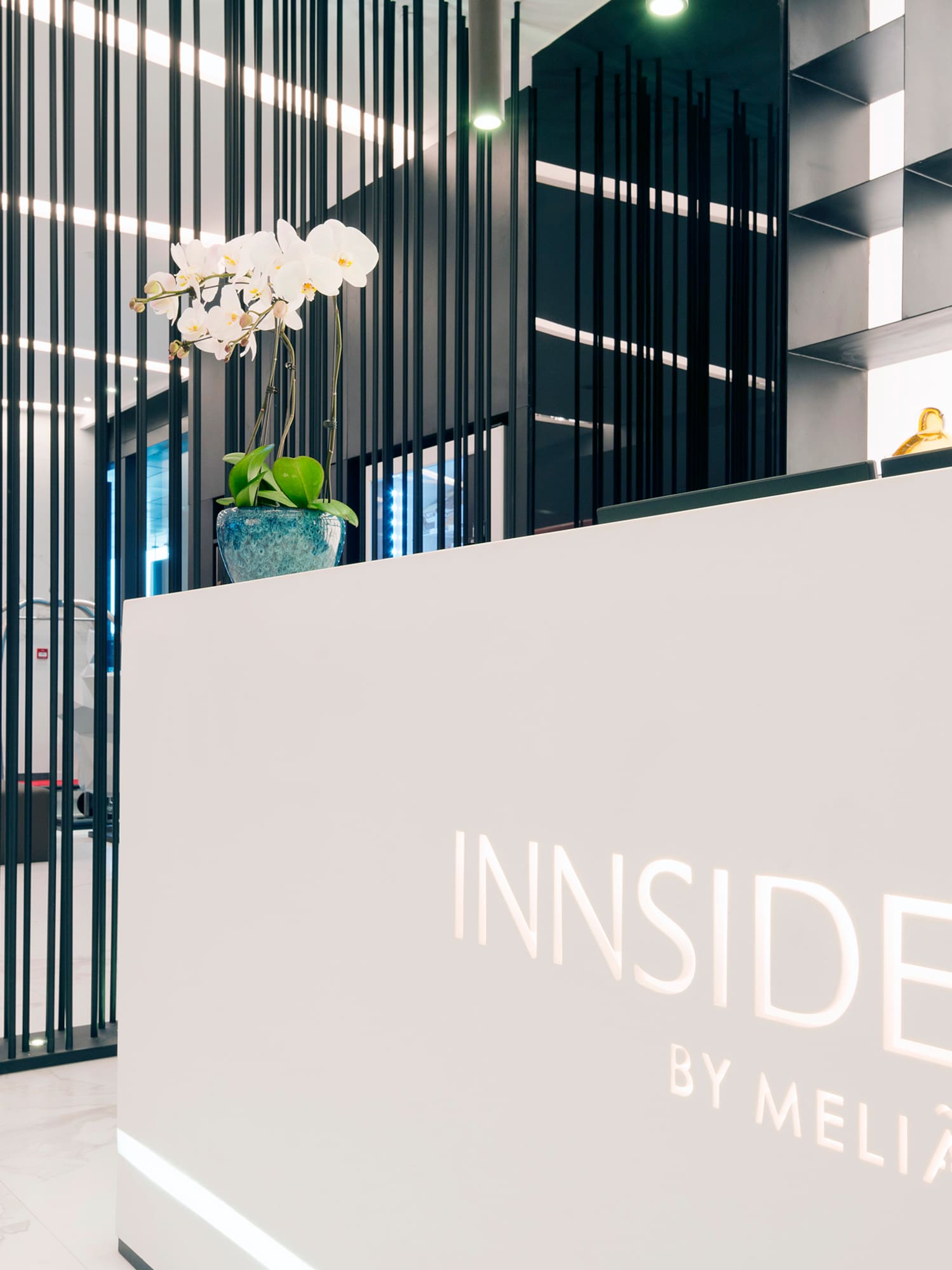 a white reception desk with black lines