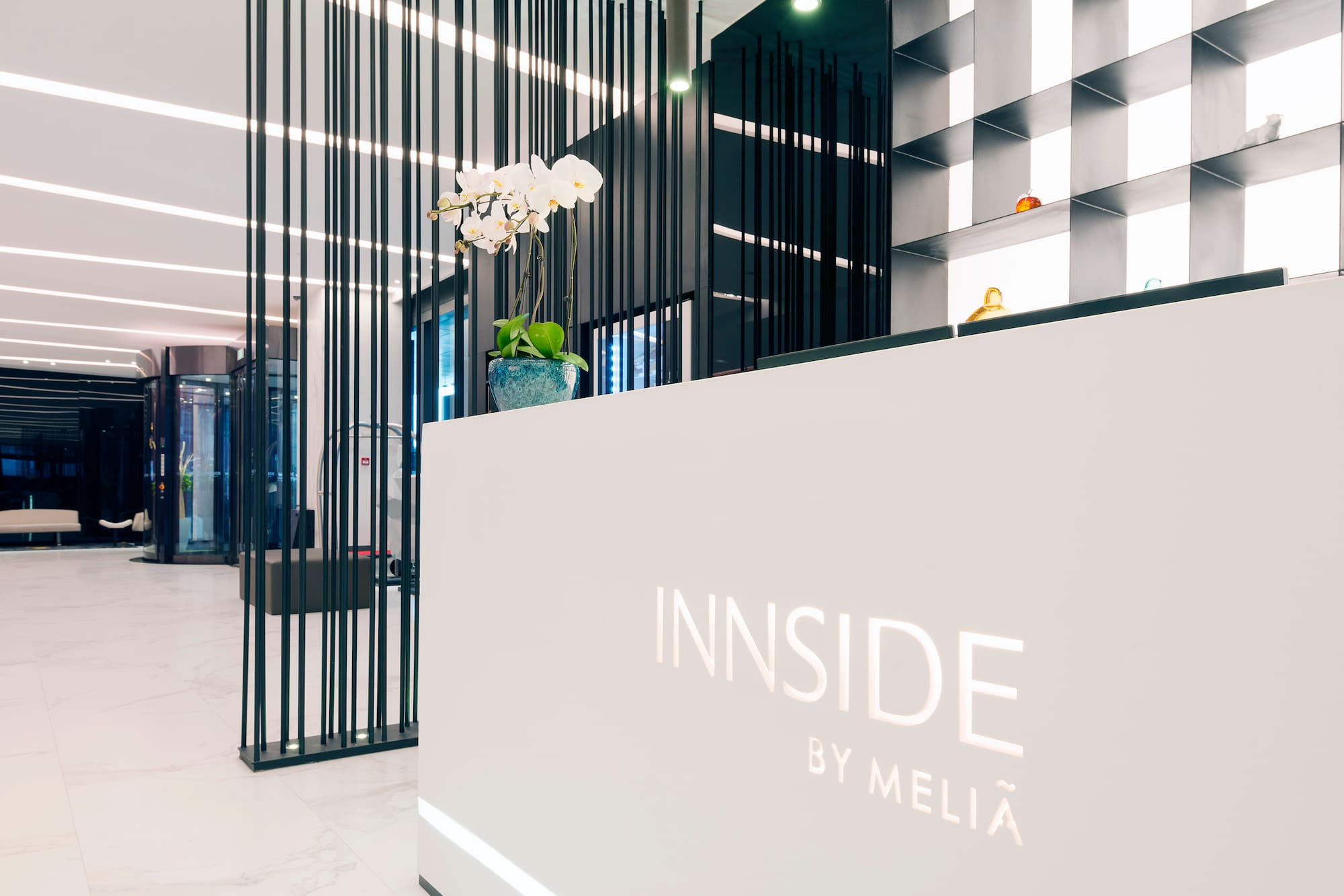 a white reception desk with black lines