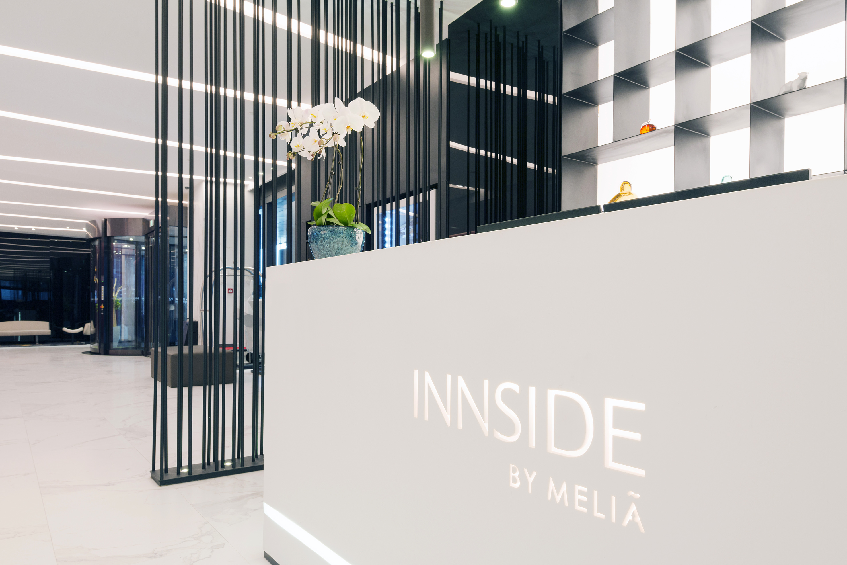 a white reception desk with black lines