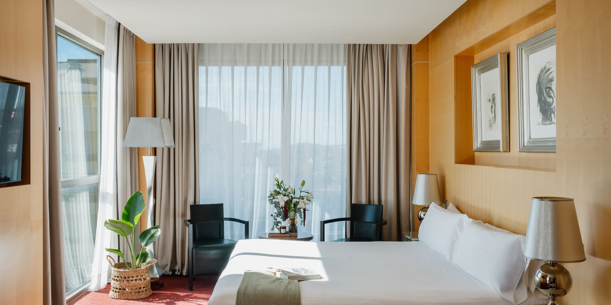 a room with a bed and chairs