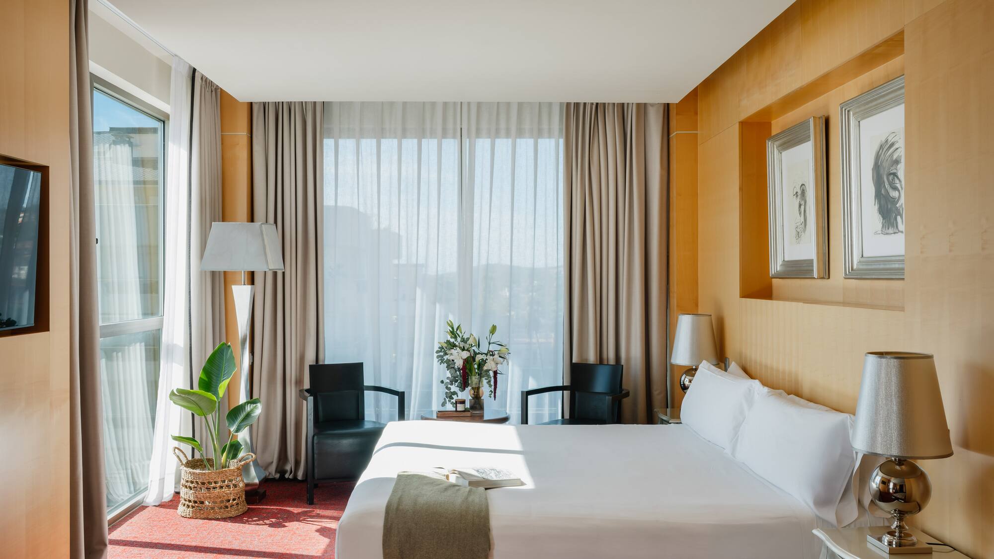 a room with a bed and chairs