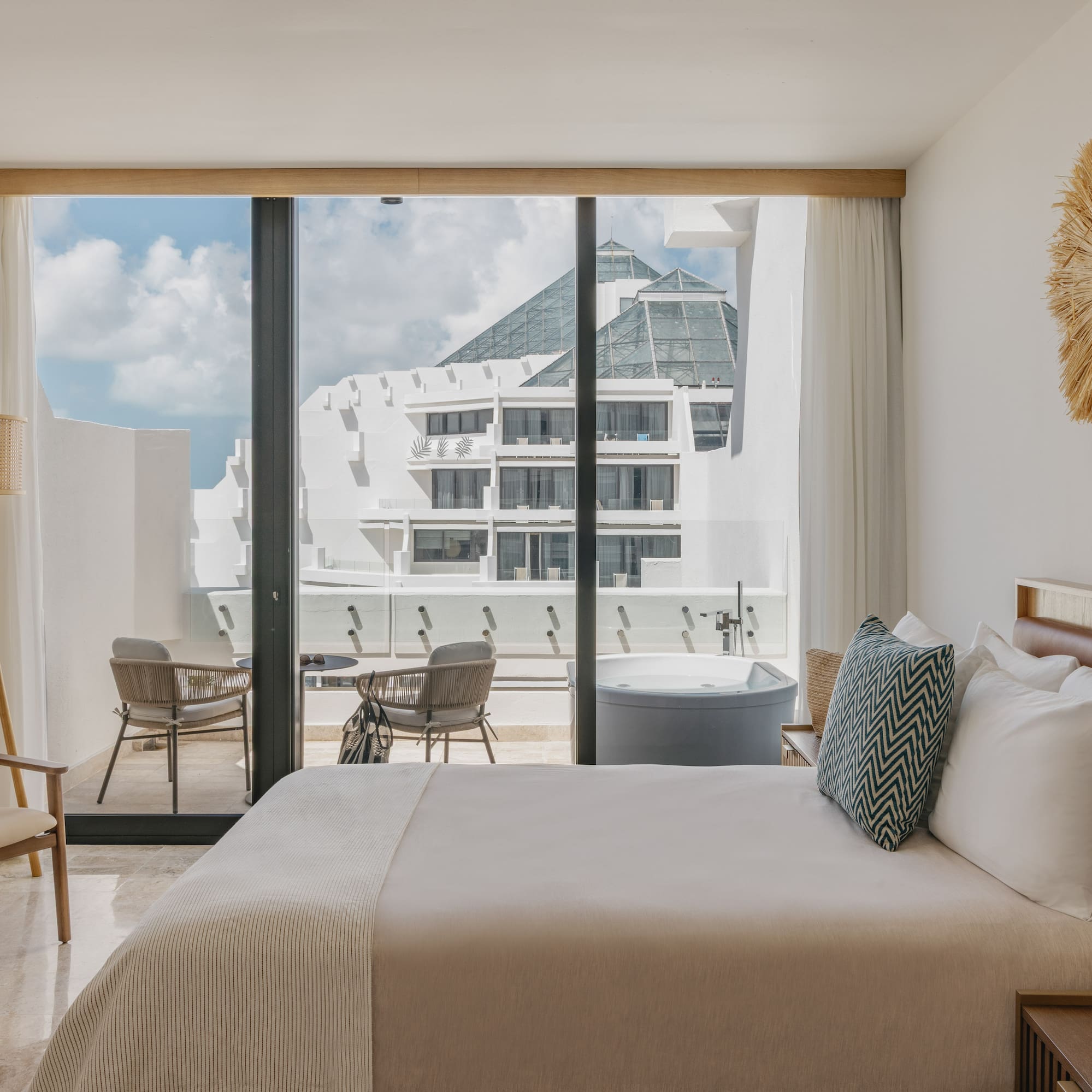 Luxury hotel room with private balcony hot tub and modern resort view.