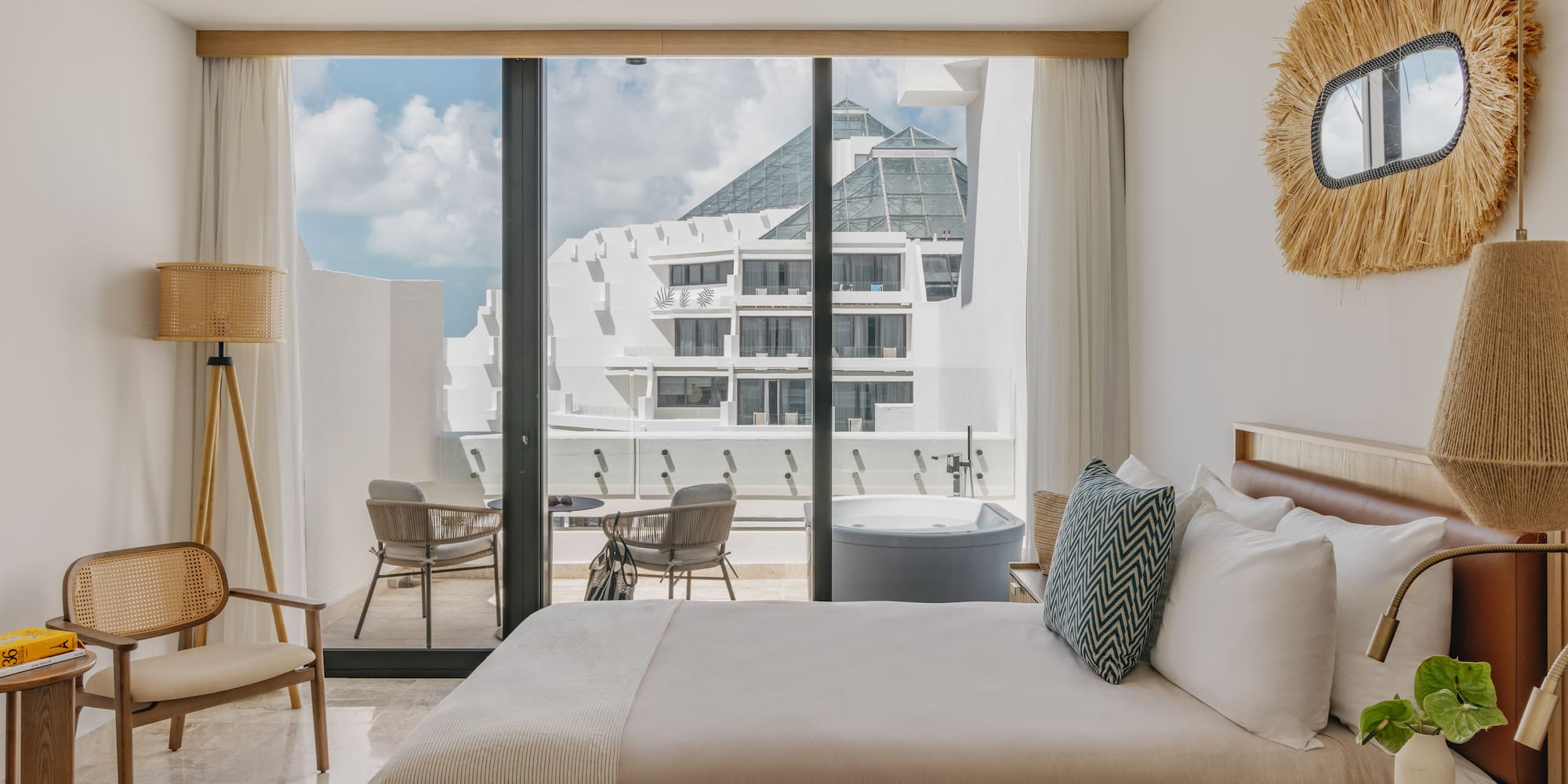 Luxury hotel room with private balcony hot tub and modern resort view.