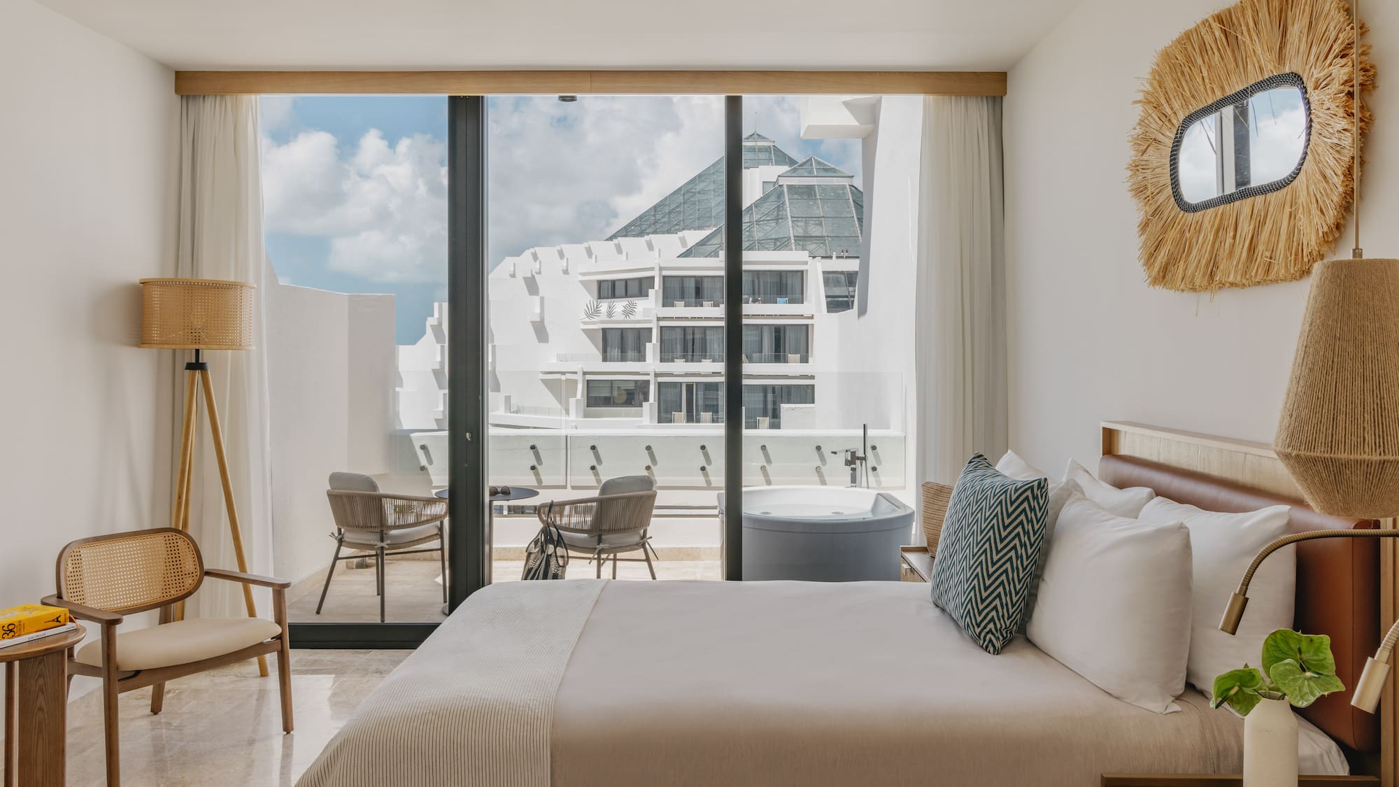 Luxury hotel room with private balcony hot tub and modern resort view.