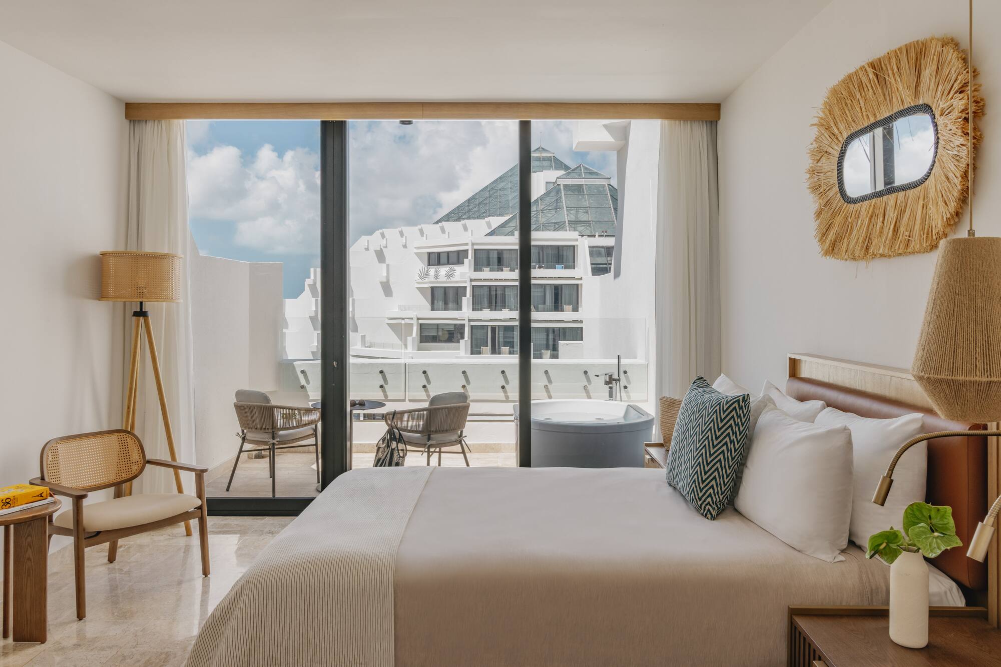Luxury hotel room with private balcony hot tub and modern resort view.