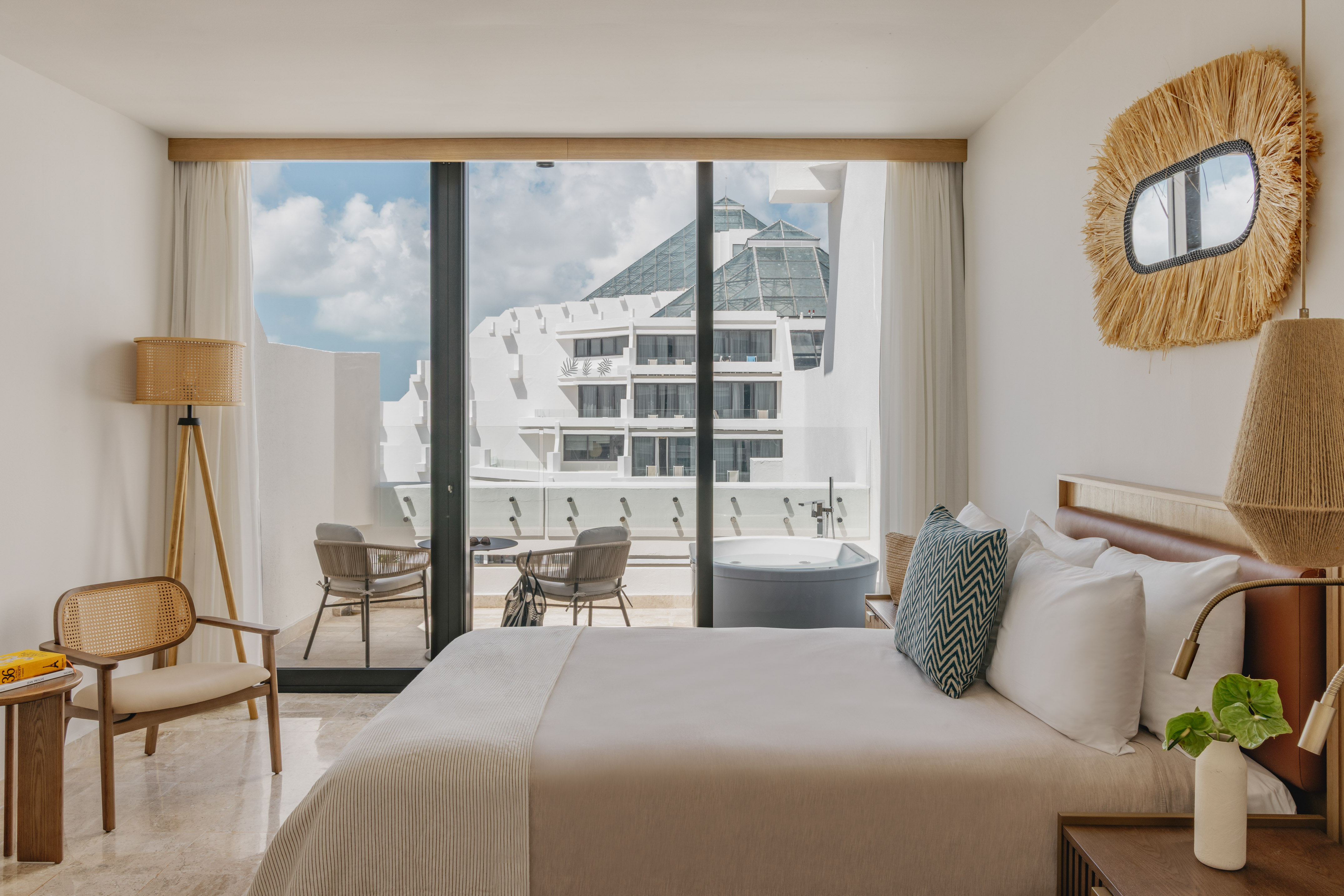 Luxury hotel room with private balcony hot tub and modern resort view.