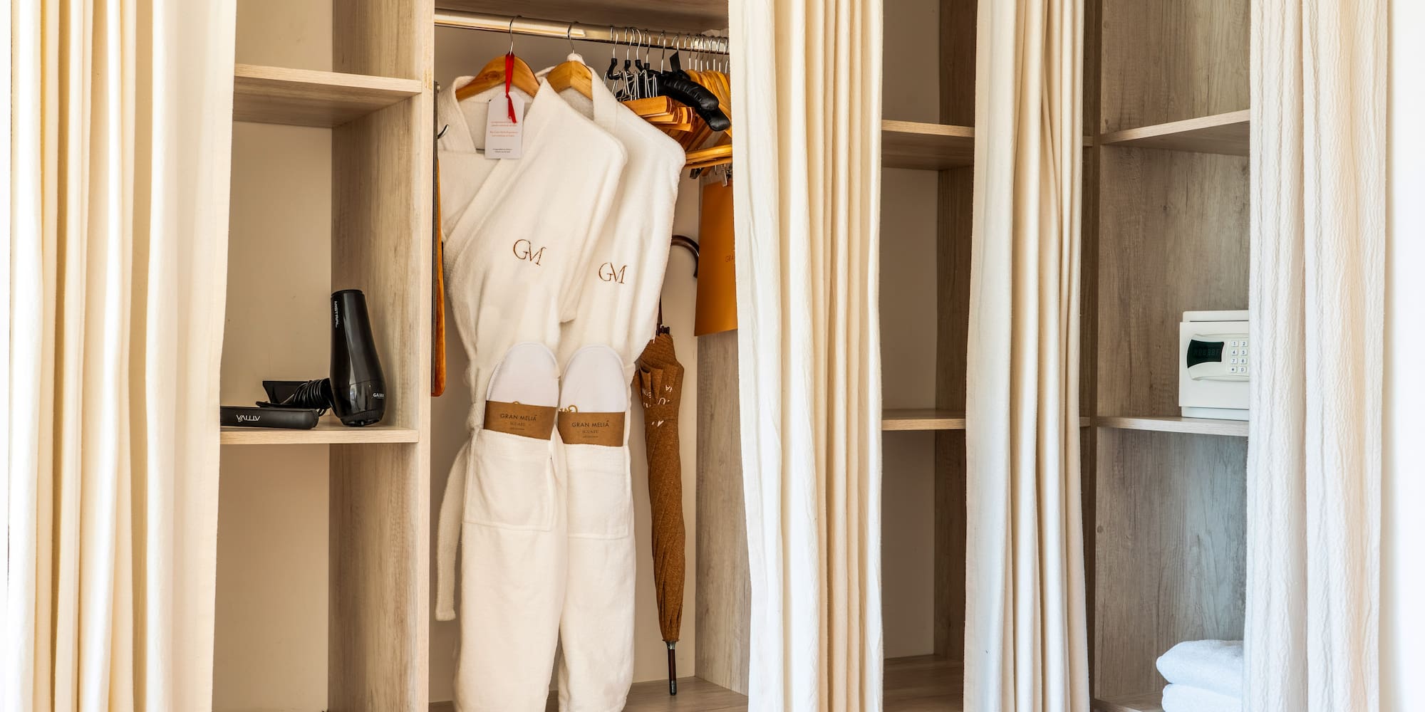 a closet with white towels and swingers