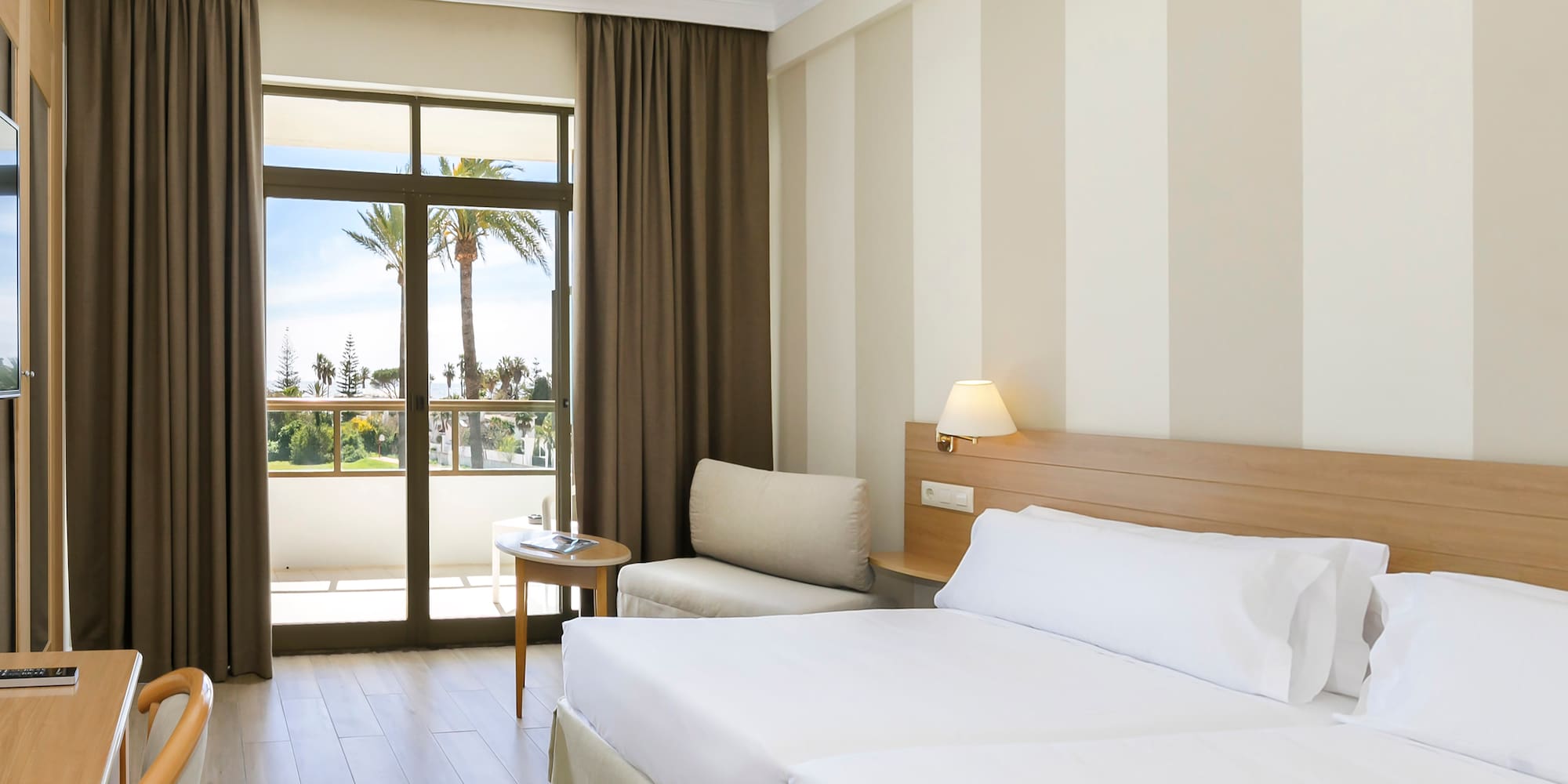 a room with two beds and a window