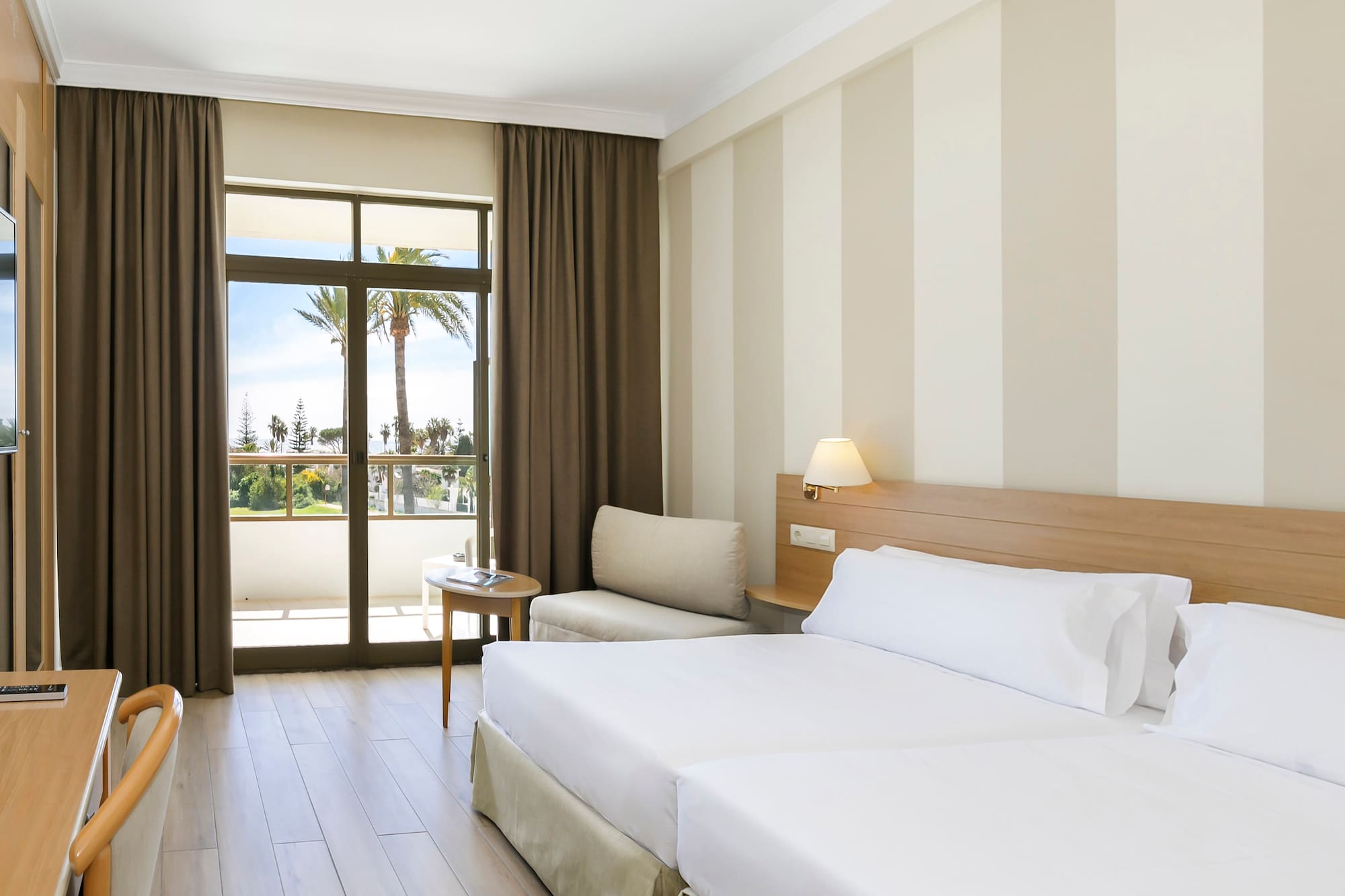 a room with two beds and a window