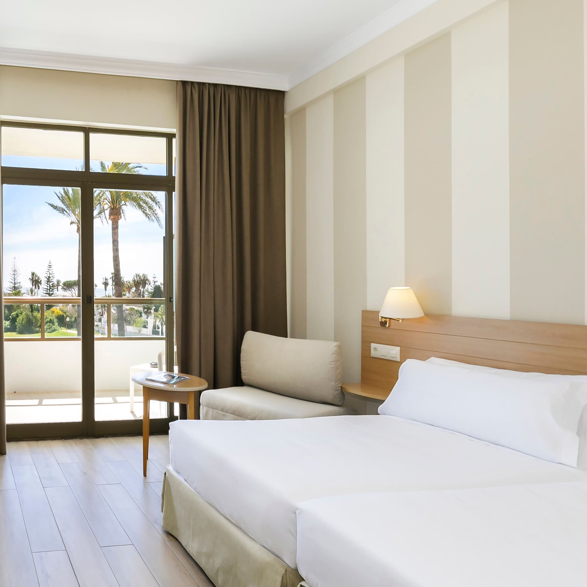 a room with two beds and a window