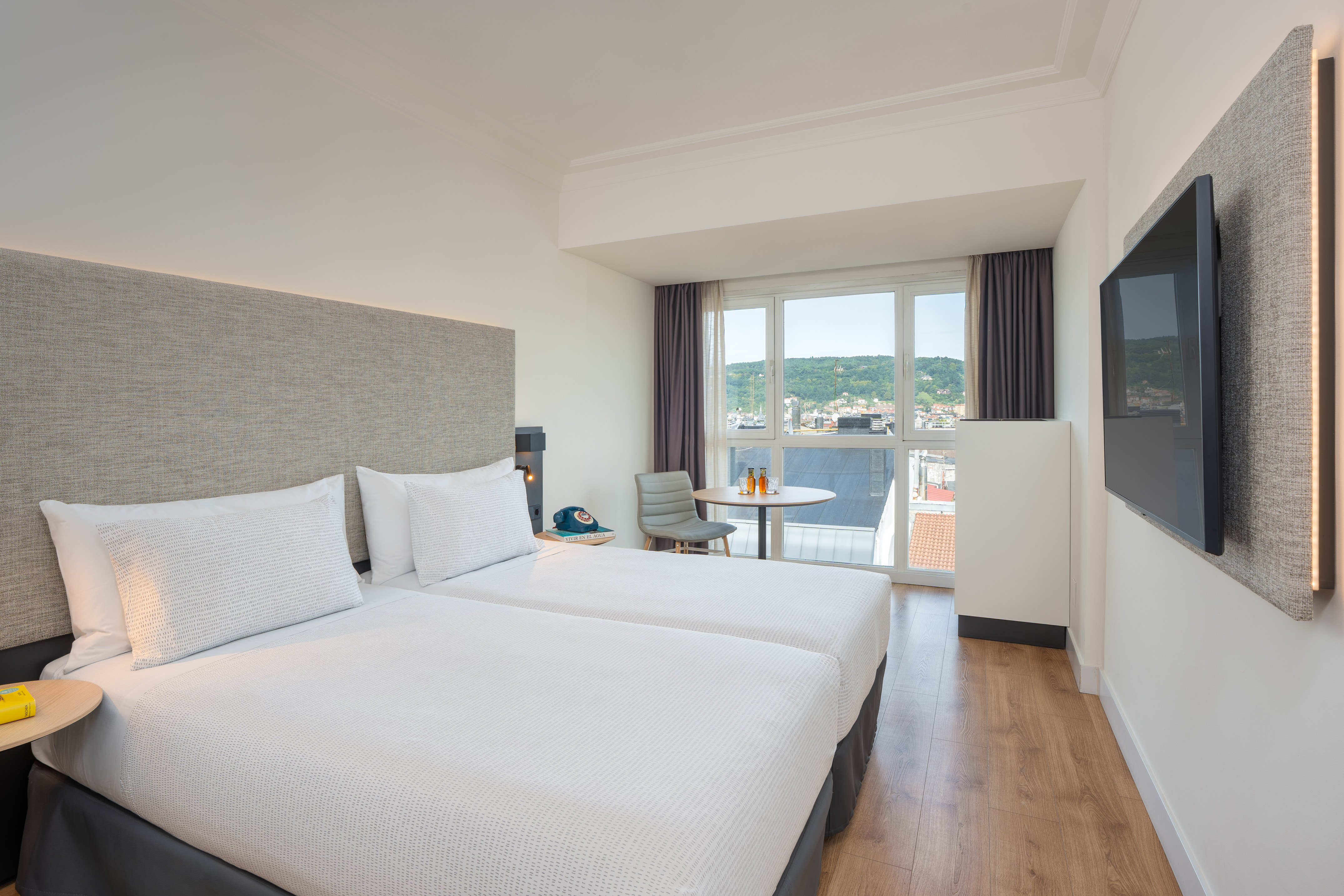 a room with two beds and a television