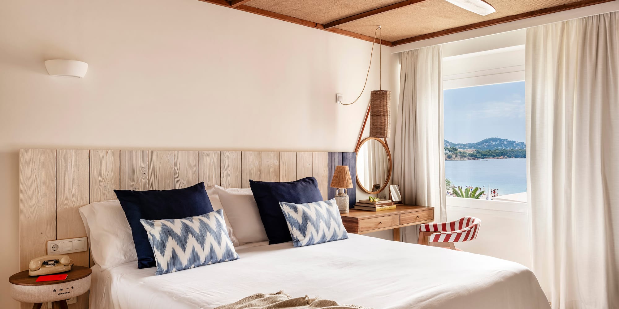 a bed with a fan and a window