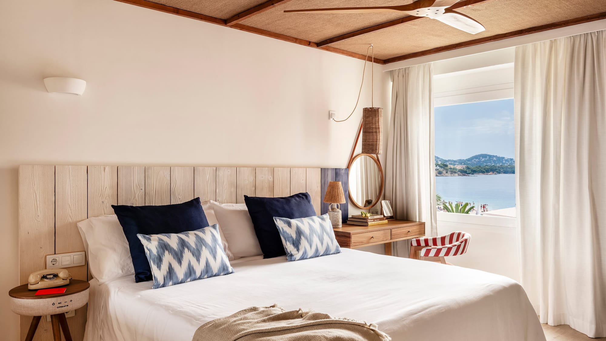 a bed with a fan and a window