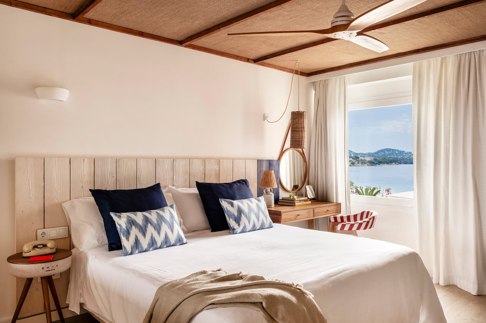 a bed with a fan and a window