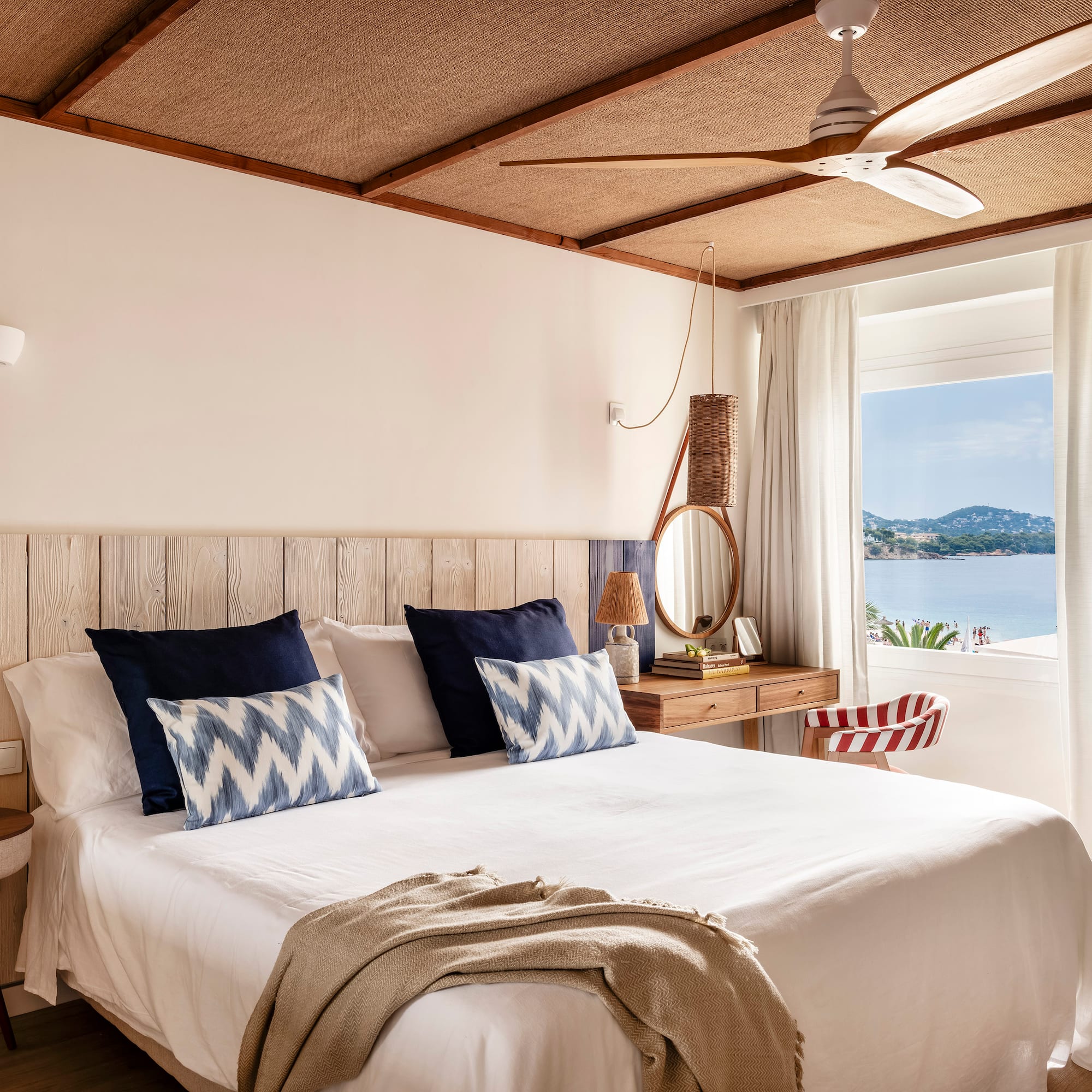 a bed with a fan and a window