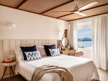 a bed with a fan and a window
