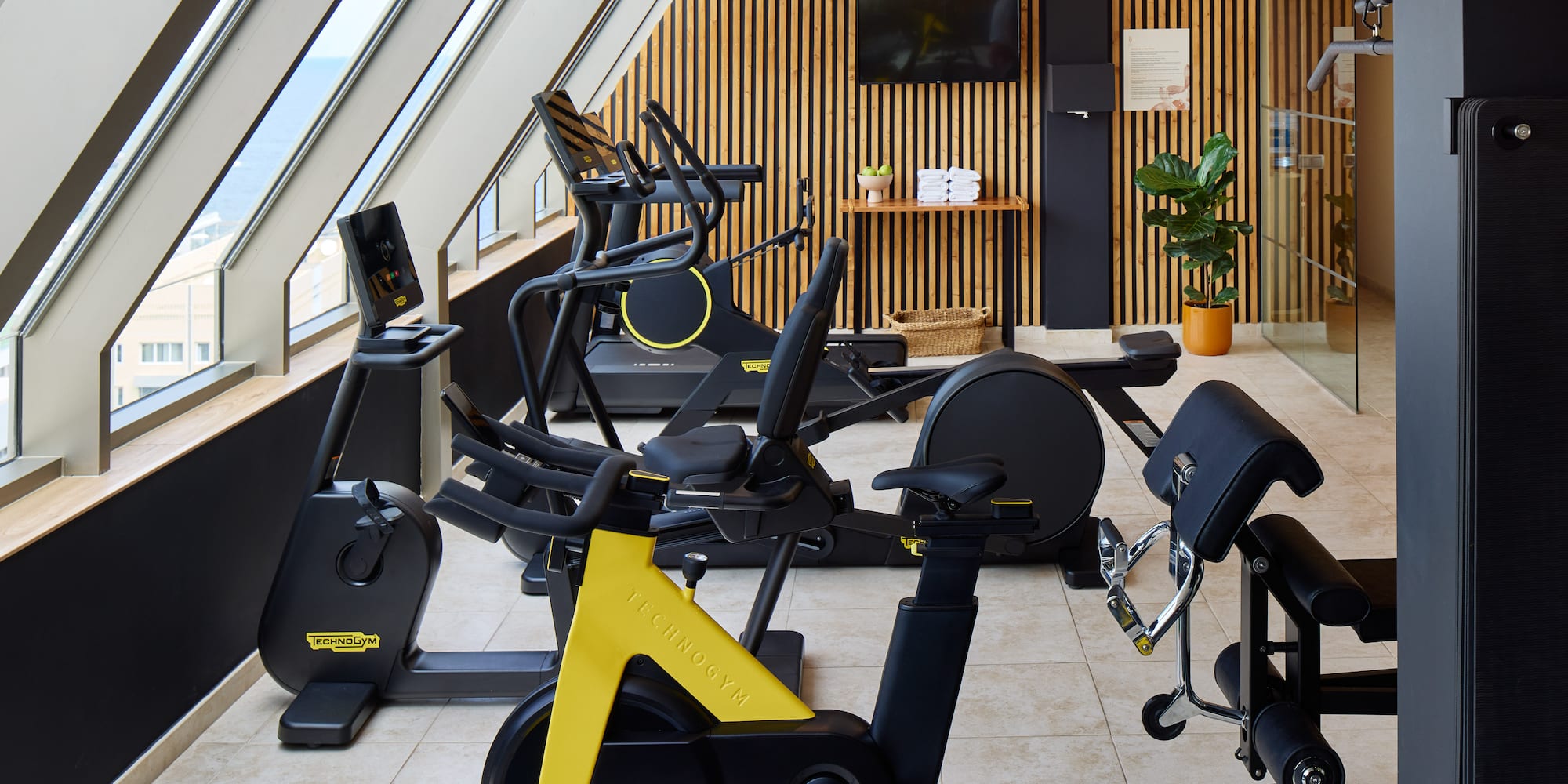 a room with exercise bikes and windows