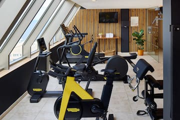 a room with exercise bikes and windows