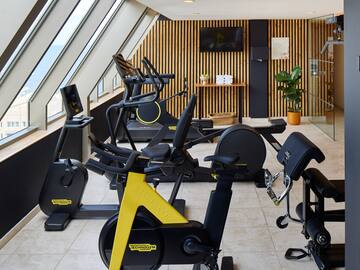 a room with exercise bikes and windows