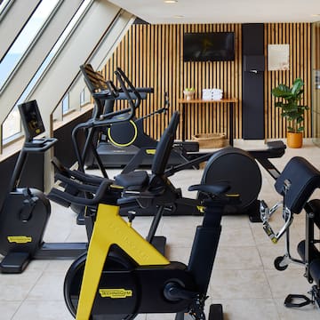 a room with exercise bikes and windows